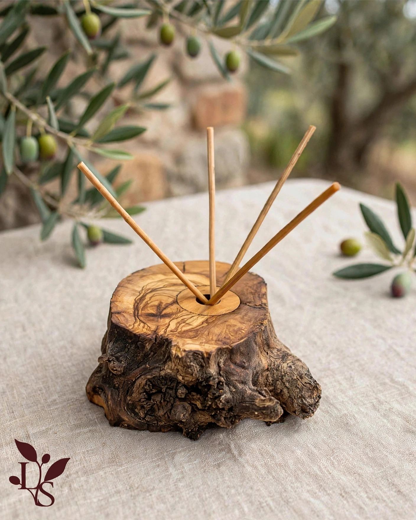 Rustic trunk diffuser with bark edge, reed sticks and olive branch